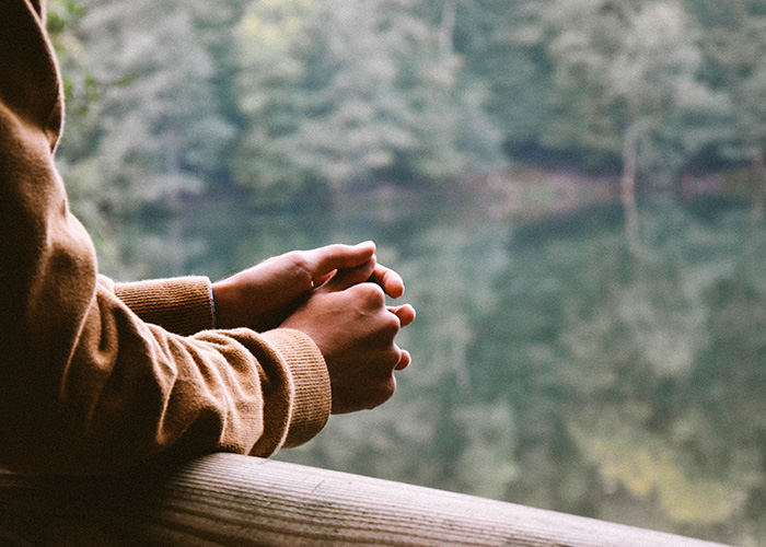 Person-Thinking-Wellbeing A person looking out over a lake